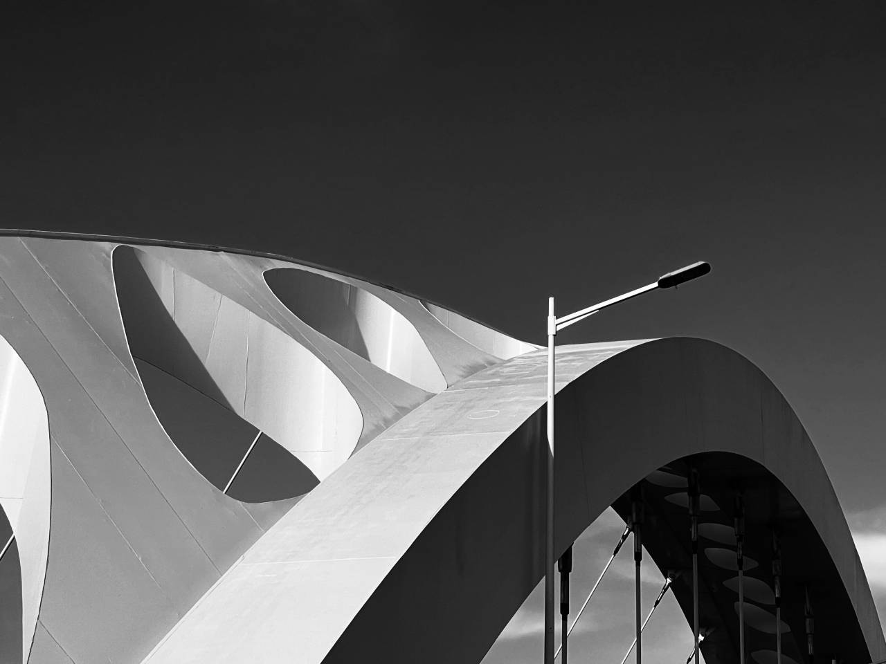 Abstract black and white architectural curves of a bridge, symbolizing the structure of regression model evaluation metrics.